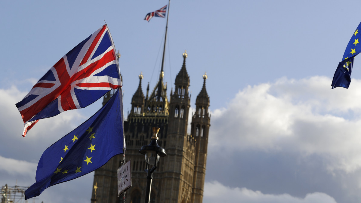 Brit és európai uniós zászlók a brit parlamentnél Londonban 2019. október 19-én. Az alsóház rendkívüli ülésén 322-306 arányban elfogadta azt a módosító indítványt, amelynek célja a brit EU-tagság megszűnésének (Brexit) feltételrendszerét rögzítő megállapodás formális jóváhagyásának halasztása a megállapodás jogi szövegének törvénybe iktatásáig.
