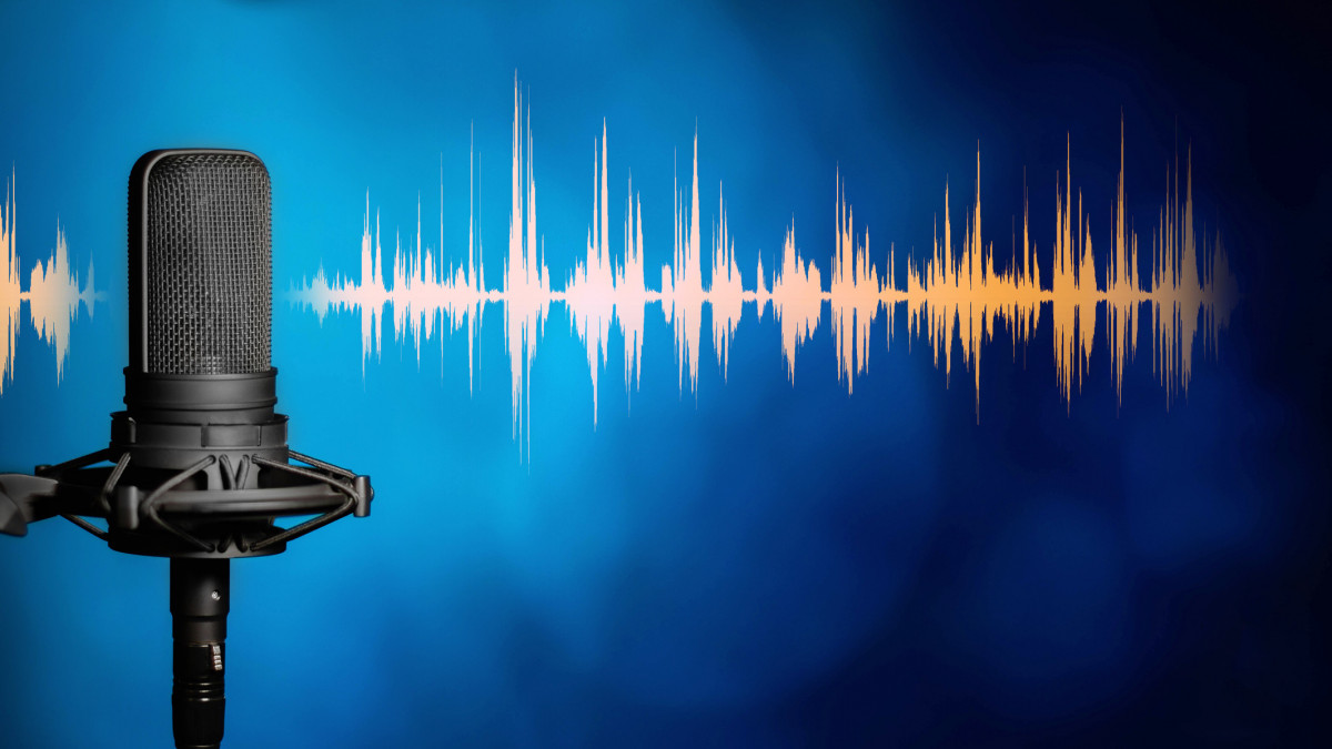 Professional studio microphone on blue background with orange audio waveform, Podcasting, broadcasting or recording studio banner