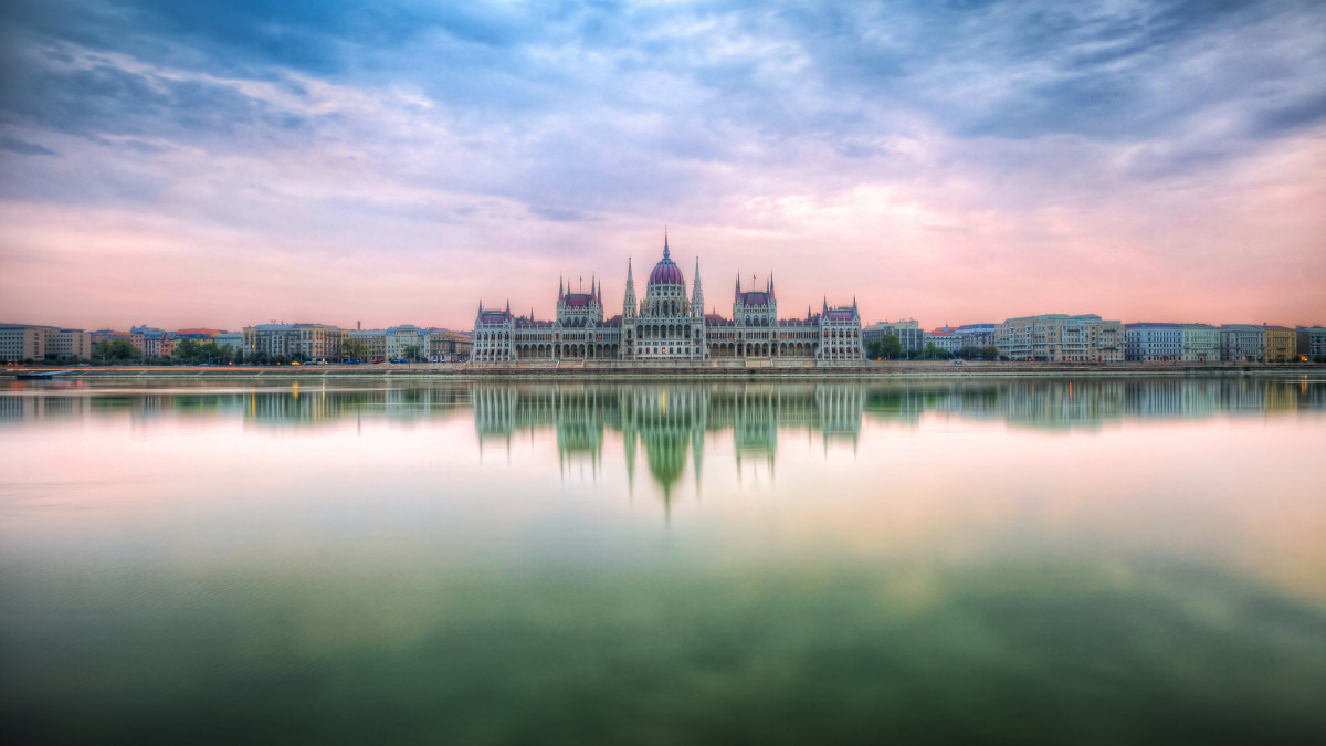 Sunrise shot of the Hungarian parliament in Budapest with a reflection in Danube