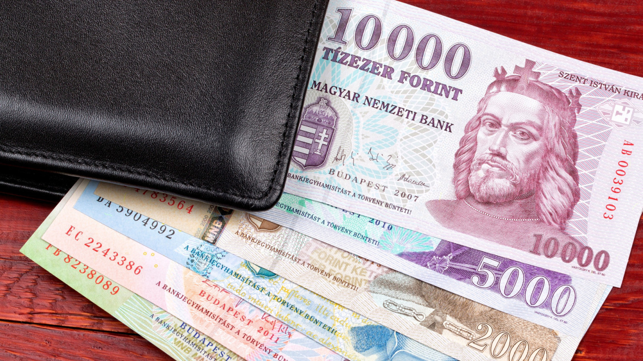 Hungarian money in the black wallet on a wooden background