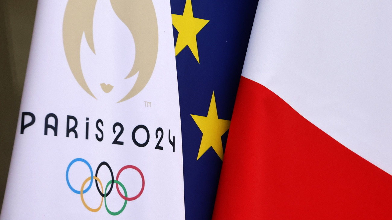 PARIS, FRANCE - JANUARY 12: The flag of the Paris 2024 Olympic Games is seen near the French national flag and the European flag at the entrance of the Elysee Palace during the first weekly cabinet meeting following a government reshuffle at the presidential Elysee Palace on January 12, 2024 in Paris, France. Frances new prime minister Gabriel Attal unveiled his cabinet overnight, two days after he was appointed. (Photo by Chesnot/Getty Images)