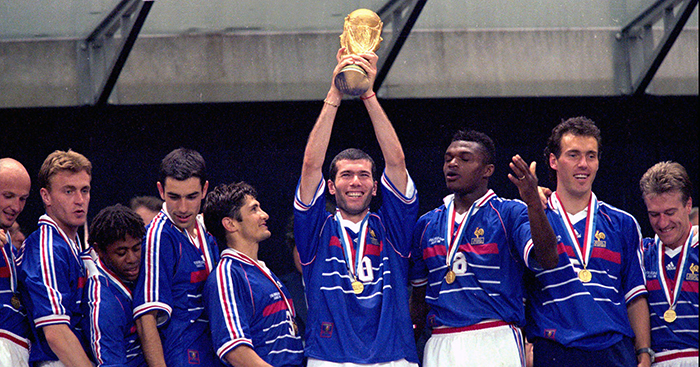 France's Zinedine Zidane holds aloft the World Cup flanked by his teammates