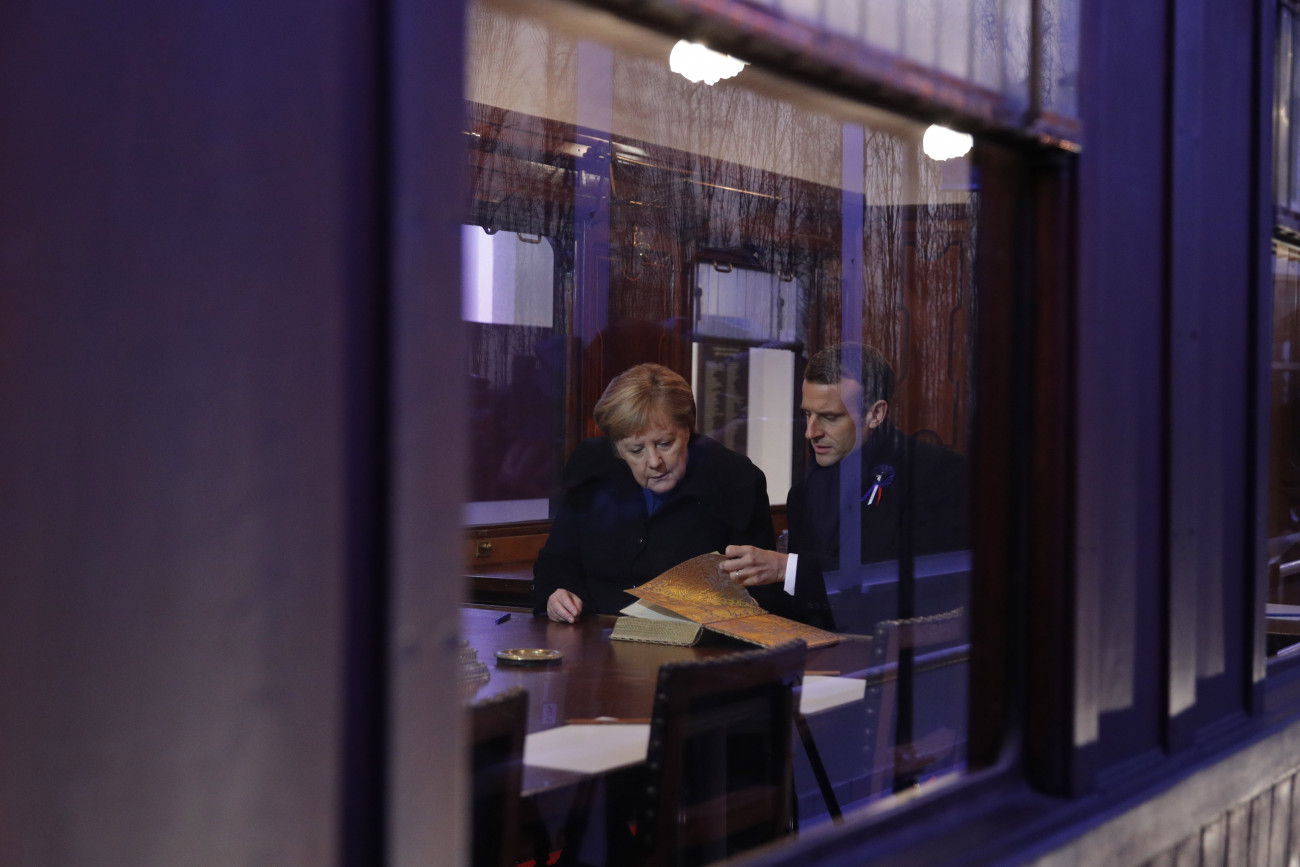 Angela Merkel német kancellár és Emmanuel Macron francia elnök az első világháborút lezáró fegyverszüneti egyezmény helyszínéül szolgáló vasúti kocsi másolatában, a Párizstól északra levő compiegne-i erdőben 2018. november 10-én, az egyezmény aláírásának századik évfordulója előtti napon. 1945 óta először emlékezett meg közösen német kancellár és francia államfő az egyezmény évfordulójáról a megkötése helyszínén.
MTI/EPA/Philippe Wojazer