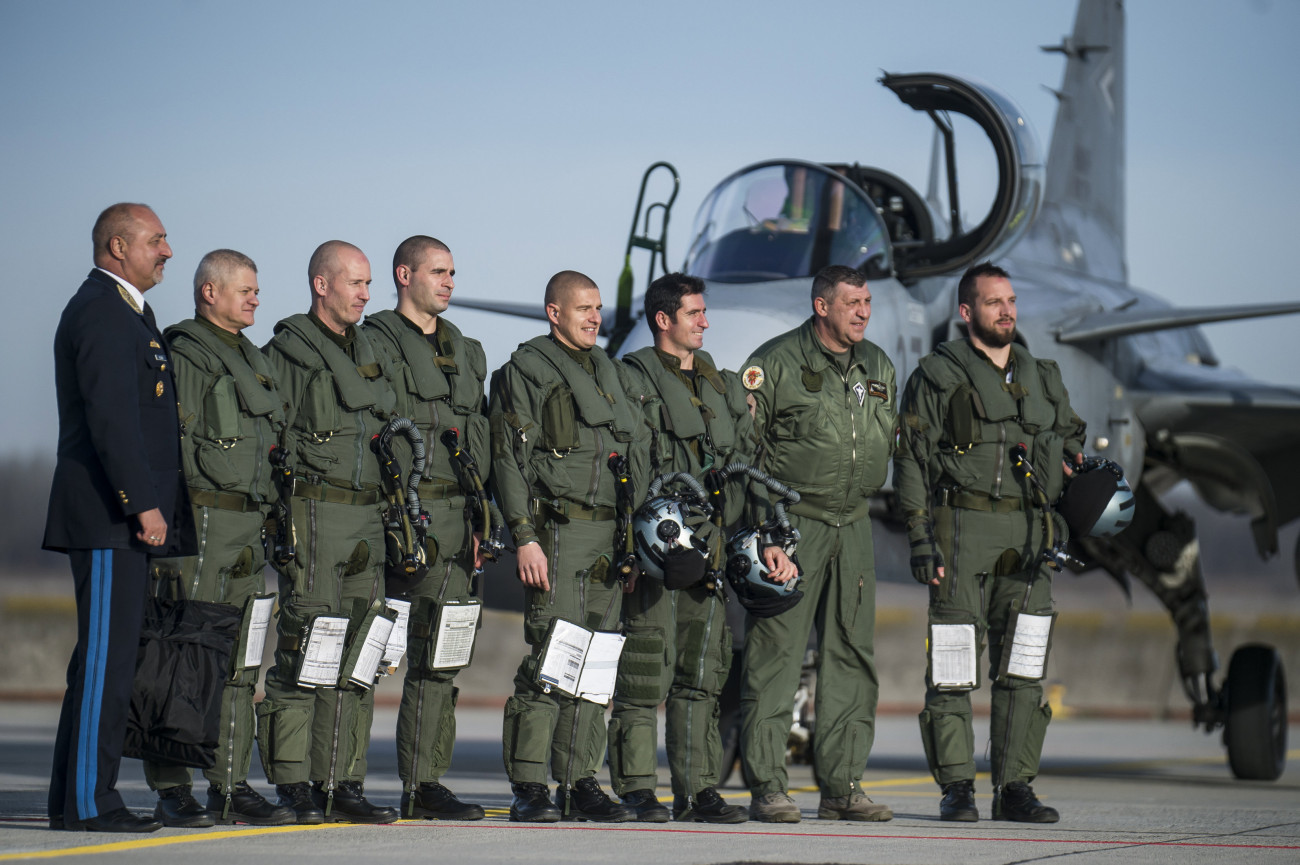 Kecskemét, 2019. december 17.
Kilián Nándor, a Magyar Honvédség Parancsnokságának légierő haderőnem szemlélője (b) és Ugrik Csaba dandártábornok, bázisparancsnok (j2) pilóták társaságában A megújult kecskeméti légi bázisra Pápáról visszaérkező Gripen vadászrepülőgépek fogadásán 2019. december 17-én. A kecskeméti bázist a NATO biztonsági beruházási programja keretében, valamint a Modern városok program részeként vegyes - katonai és polgári - használatú repülőtérré fejlesztették. A fél évig tartó felújítás alatt a Magyar Légierő 12 Gripenje Pápán állomásozott.
MTI/Ujvári Sándor