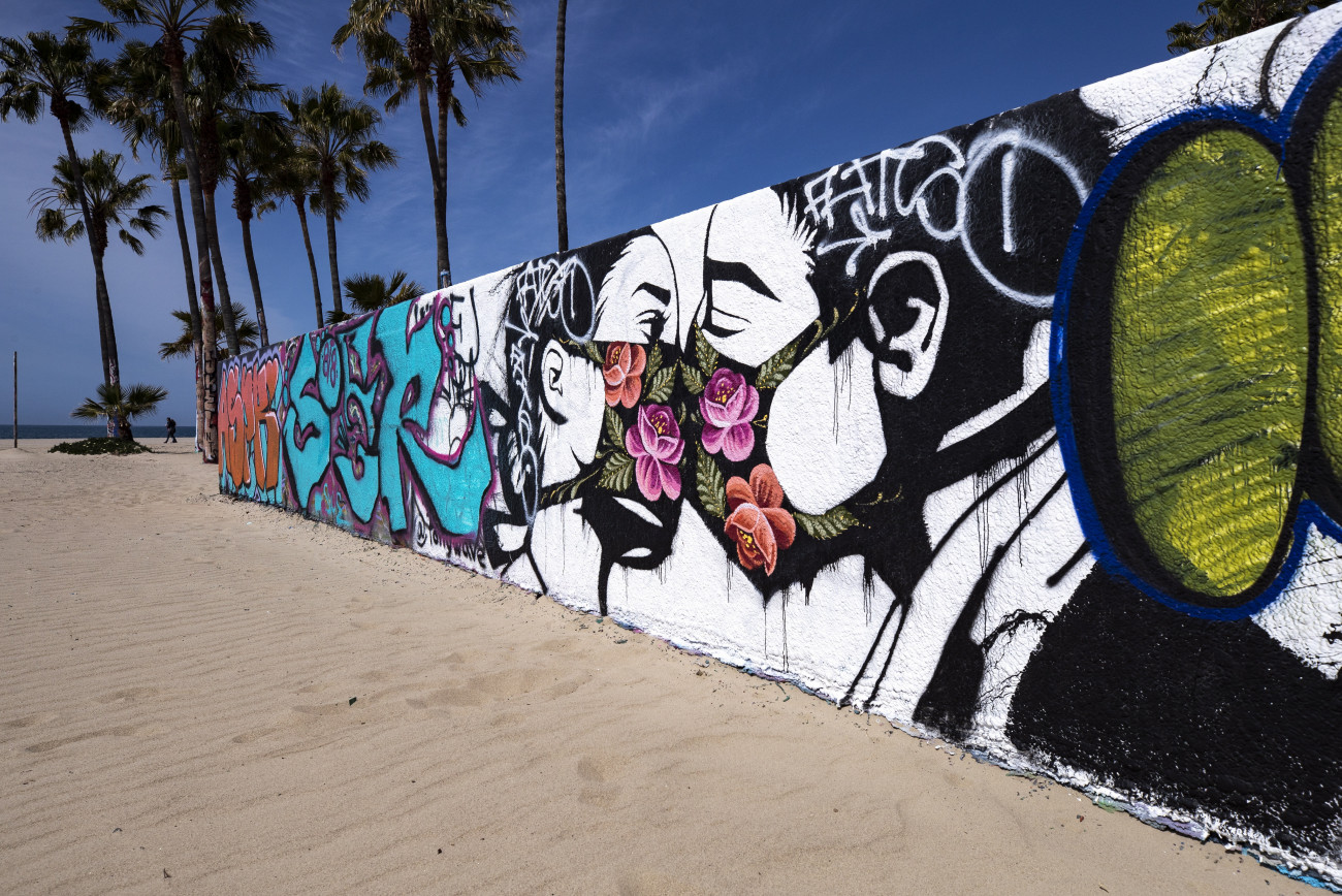 Venice, 2020. március 29.
Védőmaszkban csókolózó párt ábrázoló falfestmény a kaliforniai Venice tengerpartján 2020. március 28-án. Eric Garcetti Los Angeles-i polgármester elrendelte a strandok lezárását a koronavírus-járvány elleni küzdelem hatékonyság érdekében.
MTI/EPA/Etienne Laurent