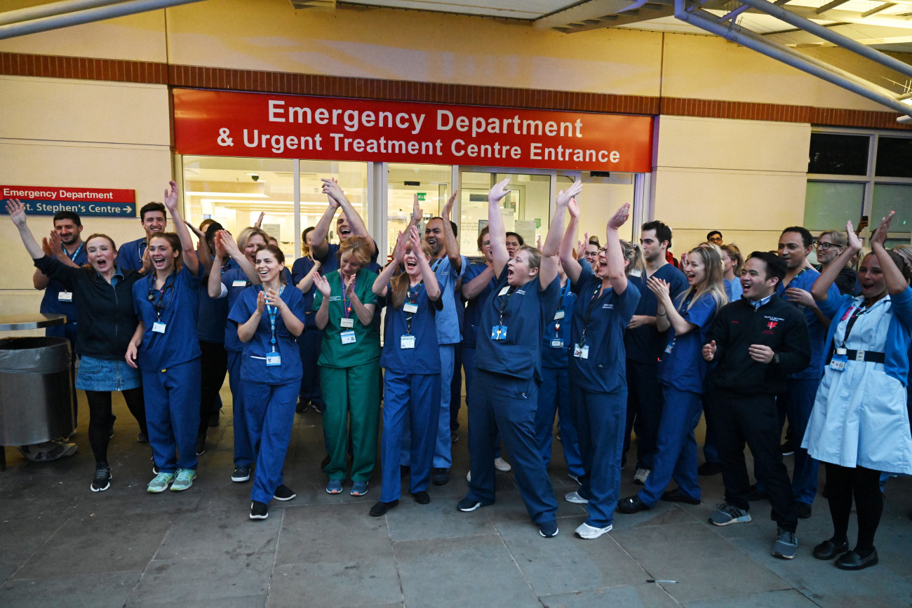 London, 2020. április 16.
Az Országos Egészségügyi Szolgálat (NHS) alkalmazottai tapsolnak a munkájukért az utcán és az erkélyeken tapsolva köszönetet mondó embereknek a Chelsea and Westminster Kórház bejárata előtt, Londonban 2020. április 16-án, a koronavírus-járvány idején.
MTI/EPA/Neil Hall