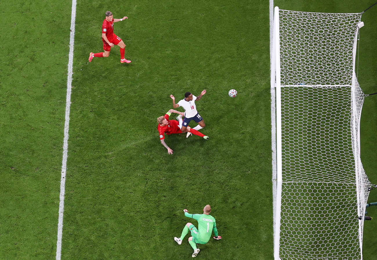 LONDON, ENGLAND - JULY 07: Simon Kjaer of Denmark scores an own goal, England's first goal, whilst under pressure from Raheem Sterling of England during the UEFA Euro 2020 Championship Semi-final match between England and Denmark at Wembley Stadium on July 07, 2021 in London, England. (Photo by Laurence Griffiths/Getty Images)