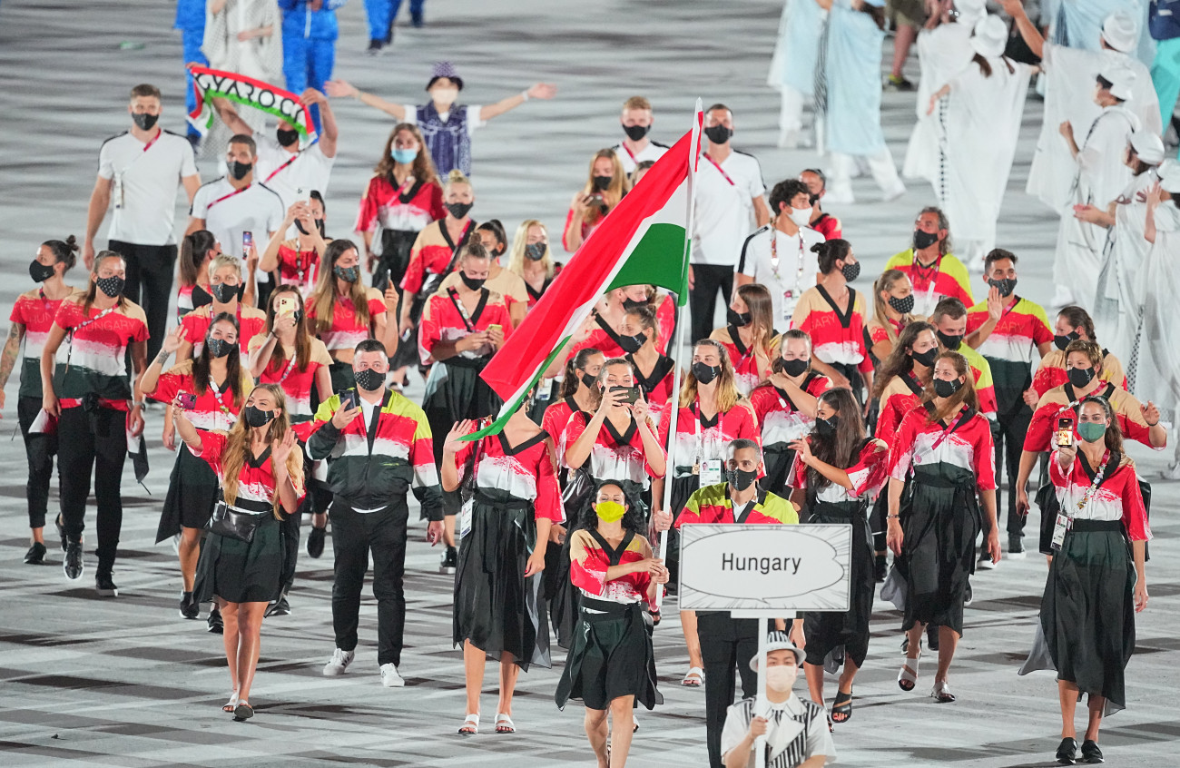23 July 2021, Japan, Tokio: Olympics: Opening ceremony at the Olympic Stadium. The team from Hungary with flag bearers fencer Aida Gabriella Mohamed and swimmer Laszlo Cseh enters the stadium. Photo: Michael Kappeler/dpa (Photo by Michael Kappeler/picture alliance via Getty Images)