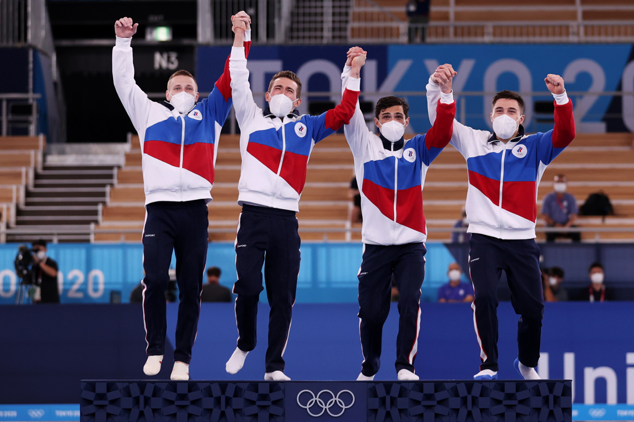 TOKYO, JAPAN - JULY 26: Denis Abliazin, David Belyavskiy, Artur Dalaloyan and Nikita Nagornyy of Team ROC react on the podium during the medal ceremony after winning the gold medal in the Men's Team Final on day three of the Tokyo 2020 Olympic Games at Ariake Gymnastics Centre on July 26, 2021 in Tokyo, Japan. (Photo by Jamie Squire/Getty Images)