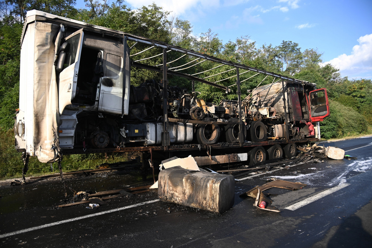 Törökbálint, 2021. szeptember 7.
Kamion kiégett pótkocsija az M0-s autóúton, Törökbálintnál 2021. szeptember 7-én. A pótkocsi, amelyen három nyerges vontató és gumiabroncsok voltak, teljes terjedelmében leégett.
MTI/Mihádák Zoltán