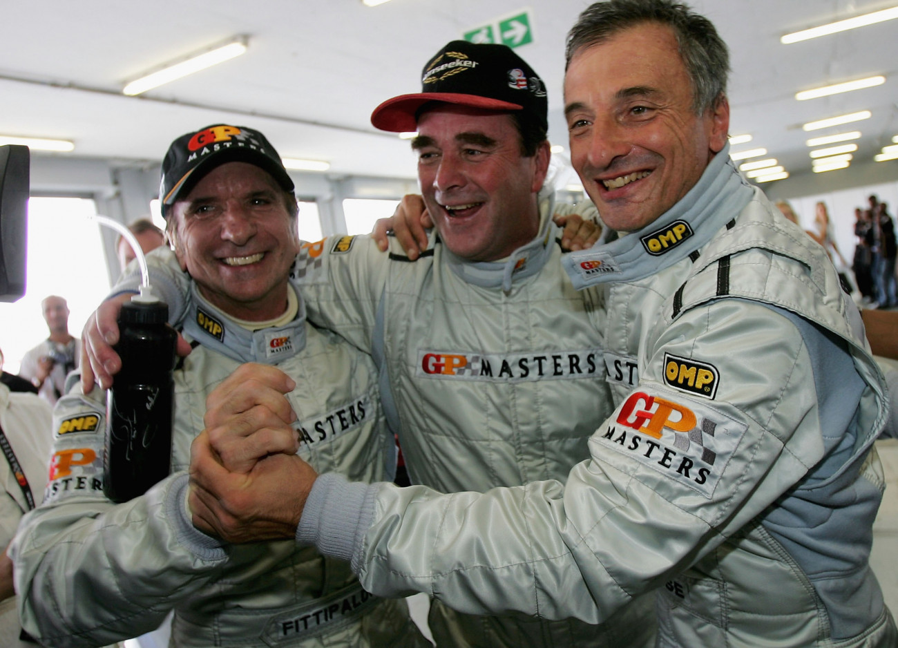 JOHANNESBURG, SOUTH AFRICA - NOVEMBER 12:  Nigel Mansell of Great Britain celebrates his pole position with Emerson Fittipaldi (2nd Place) and Ricardo Patrese (3rd) after Qualifying for the Grand Prix Masters race at the Kyalami Circuit on November 12, 2005 in Johannesburg, South Africa.  (Photo by Clive Rose/Getty Images)