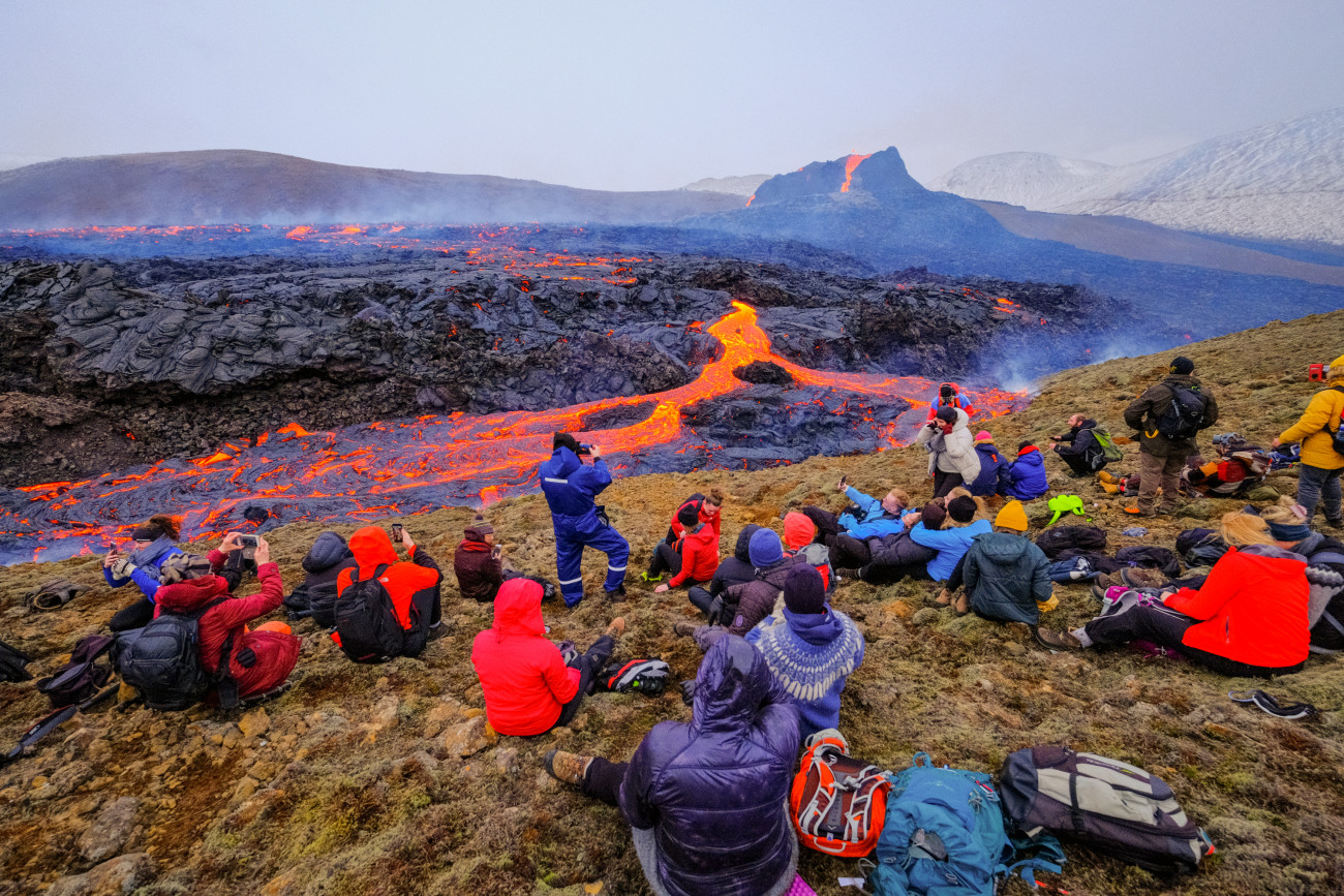 REYKJANES PENINSULA, ICELAND - MARCH 25: Hikers look at lava flows from the erupting Fagradalsfjall volcano in Geldingadalur on March 25, 2021 in Reykjanes Peninsula, Iceland. On March 19 the Icelandic meteorological office announced a volcano, referring to a mountain located south-west of the Capital Reykjavik has erupted after thousands of small earthquakes in the area over the recent weeks. This was the first eruption on the Reykjanes Peninsula in approximately 800 years. (Photo by Matthew Eisman/Getty Images)