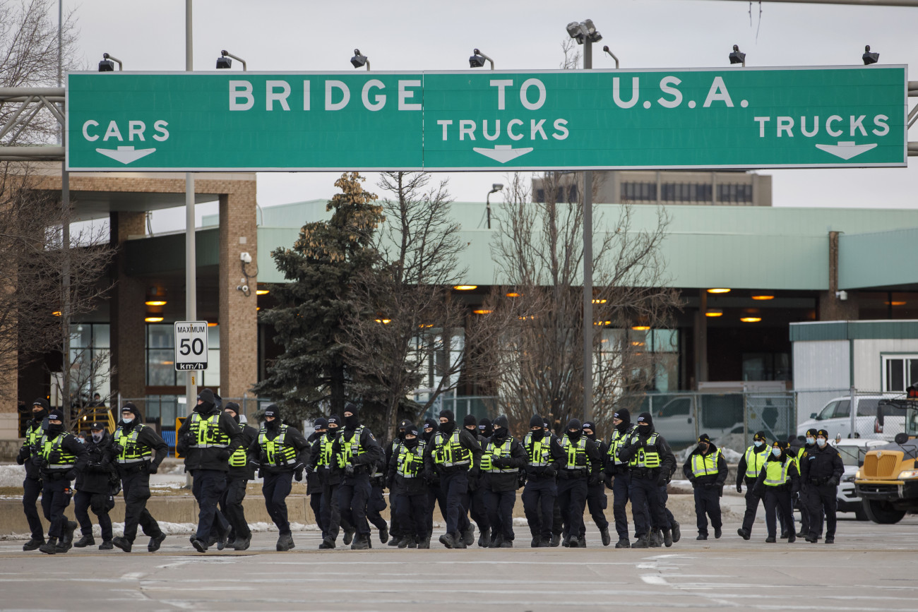 WINDSOR, ON - FEBRUARY 12: Police arrive to clear protestors and their vehicles from a blockade at the entrance to the  Ambassador Bridge, that was sealing off the flow of commercial traffic over the bridge into Canada from Detroit, on February 12, 2022 in Windsor, Canada. As a convoy of truckers and supporters continues to occupy Ottawas downtown, blockades and convoys have popped up around the country in support of the protest against Canadas COVID-19 vaccine mandate for cross-border truckers. (Photo by Cole Burston/Getty Images)