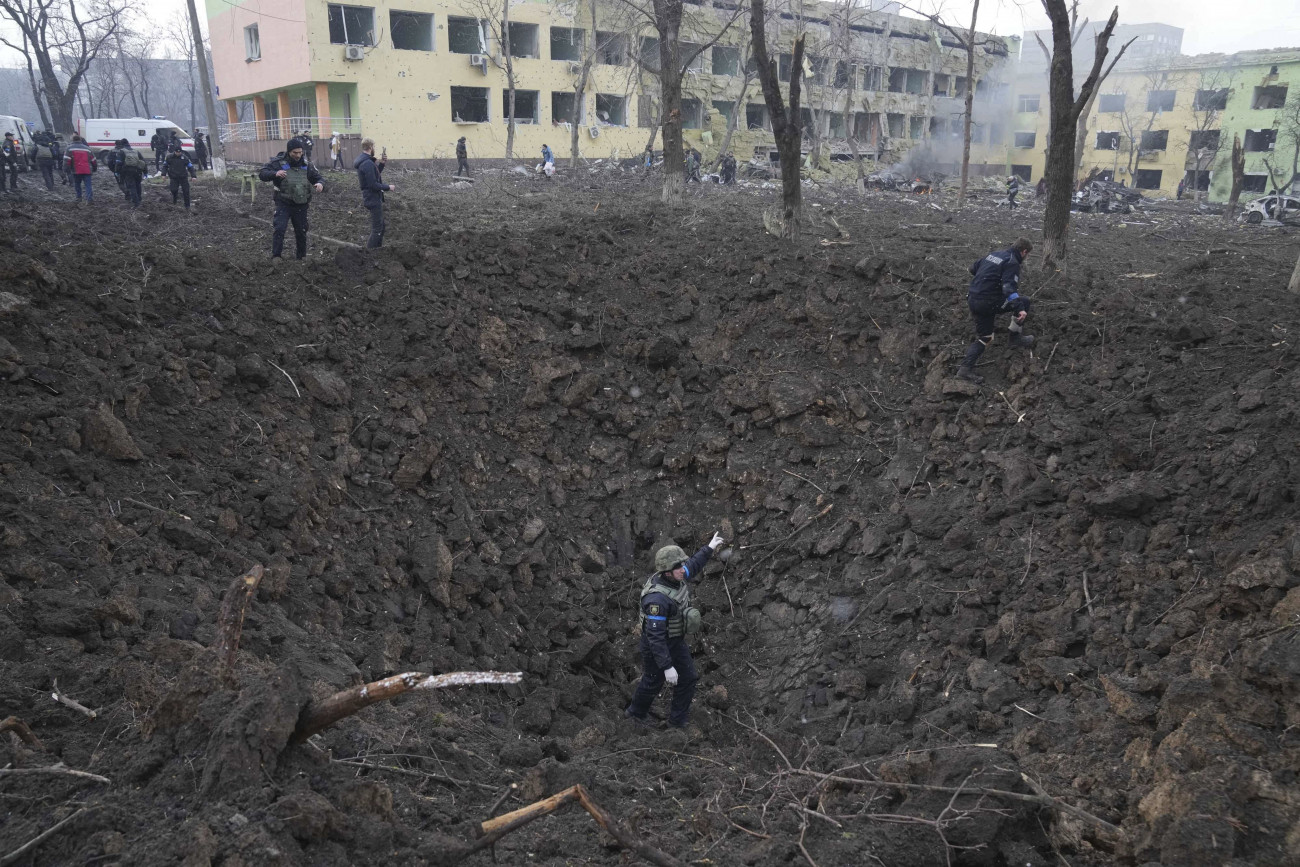 Mariupol, 2022. március 9.
Ukrán katonák és mentőalakulatok tagjai dolgoznak a bombatámadásban megrongálódott mariupoli gyermekkórháznál 2022. március 9-én. Vlagyimir Putyin orosz elnök február 24-én rendelte el katonai művelet végrehajtását Ukrajnában.
MTI/AP/Jevhen Maloletka