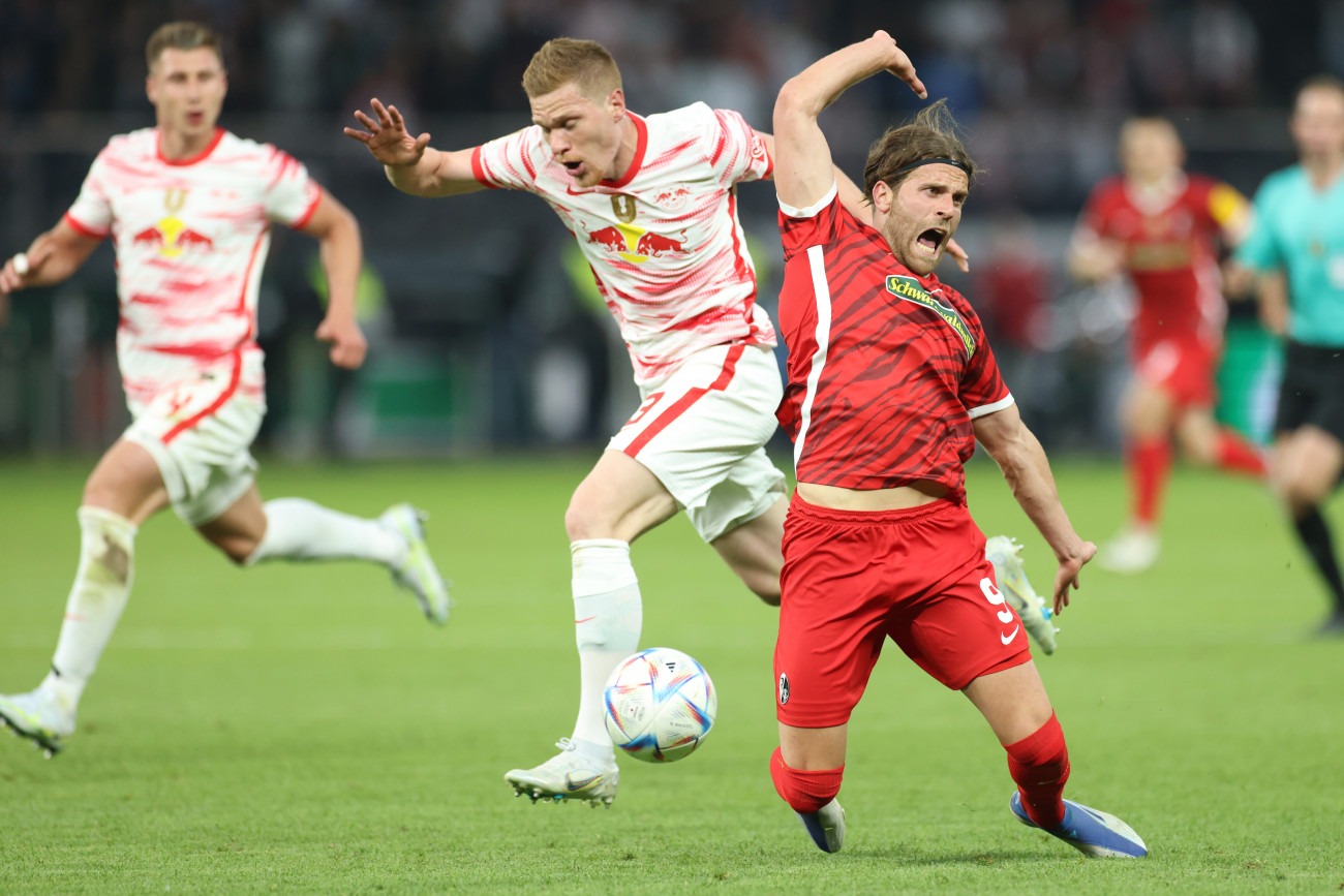 21 May 2022, Berlin: Soccer: DFB Cup, SC Freiburg - RB Leipzig, Final, at the Olympiastadion, Leipzig's Marcel Halstenberg and Freiburg's Lucas HĂśler (r) fight for the ball. IMPORTANT NOTE: In accordance with the requirements of the DFL Deutsche FuĂball Liga and the DFB Deutscher FuĂball-Bund, it is prohibited to use or have used photographs taken in the stadium and/or of the match in the form of sequence pictures and/or video-like photo series. Photo: Christian Charisius/dpa (Photo by Christian Charisius/picture alliance via Getty Images)