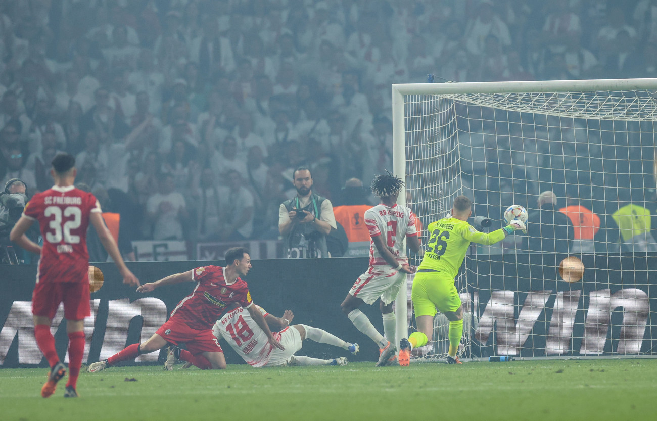 21 May 2022, Berlin: Soccer: DFB Cup, SC Freiburg - RB Leipzig, Final, at the Olympiastadion, Leipzig's Christopher Nkunku (M) scores the 1:1. IMPORTANT NOTE: In accordance with the requirements of the DFL Deutsche FuĂball Liga and/or the DFB Deutscher FuĂball-Bund, it is prohibited to use or have used photo recordings made in the stadium and/or of the match in the form of sequence pictures and/or video-like photo series. Photo: Christian Charisius/dpa (Photo by Christian Charisius/picture alliance via Getty Images)