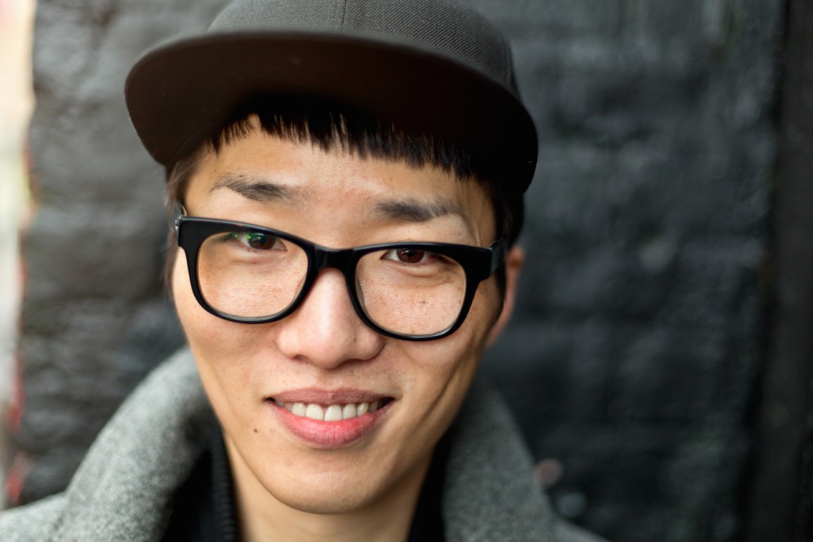 Portrait of bespectacled young man with cap