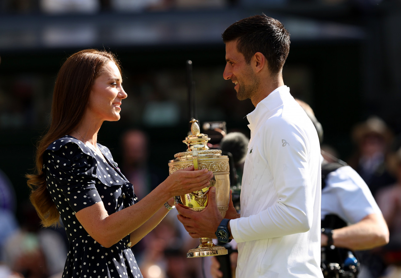 LONDON, ENGLAND - JULY 10: Catherine, Duchess of Cambridge hands over the trophy to winner Novak Djokovic of Serbia following his victory against Nick Kyrgios of Australia during their Men's Singles Final match on day fourteen of The Championships Wimbledon 2022 at All England Lawn Tennis and Croquet Club on July 10, 2022 in London, England. (Photo by Clive Brunskill/Getty Images)