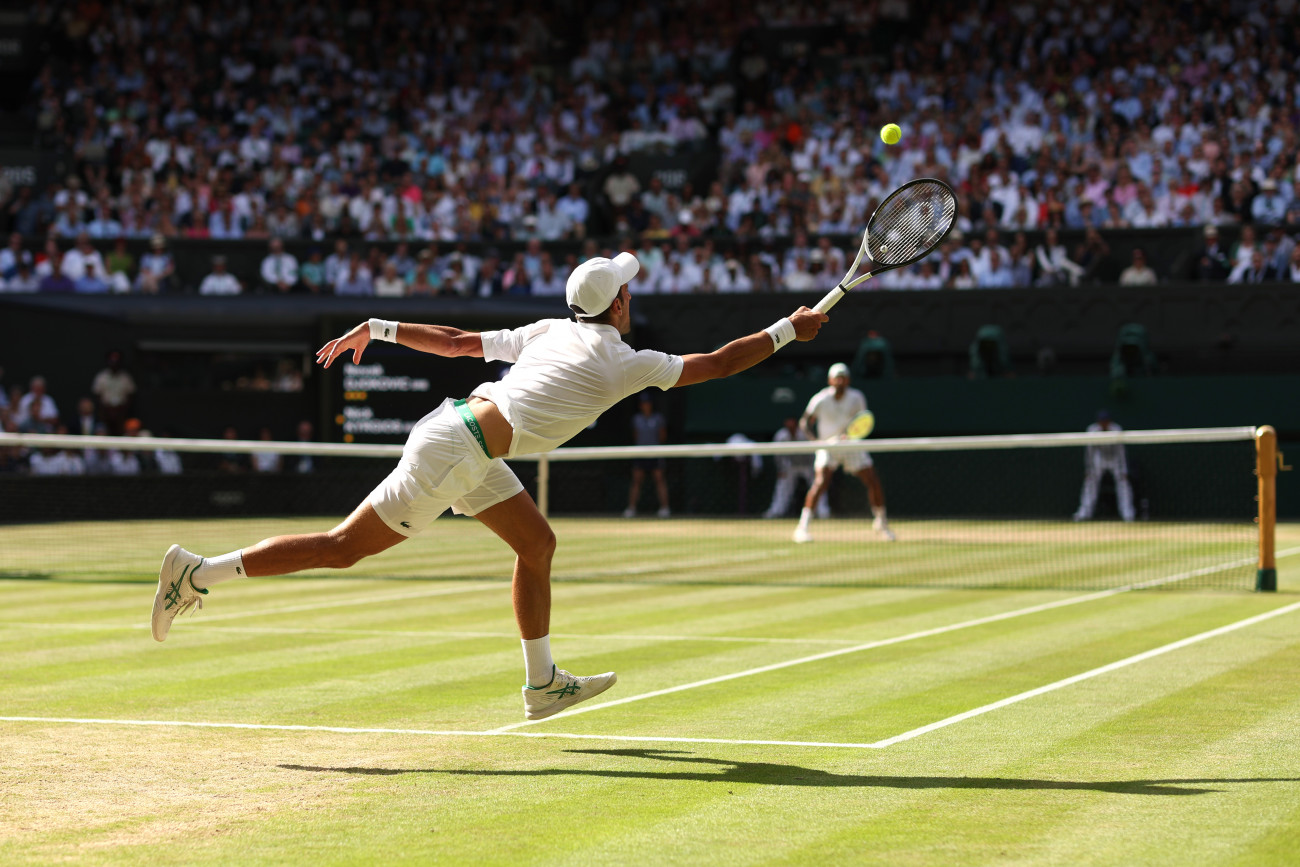 LONDON, ENGLAND - JULY 10: Novak Djokovic of Serbia stretches to play a forehand against Nick Kyrgios of Australia during their Men's Singles Final match on day fourteen of The Championships Wimbledon 2022 at All England Lawn Tennis and Croquet Club on July 10, 2022 in London, England. (Photo by Julian Finney/Getty Images)
