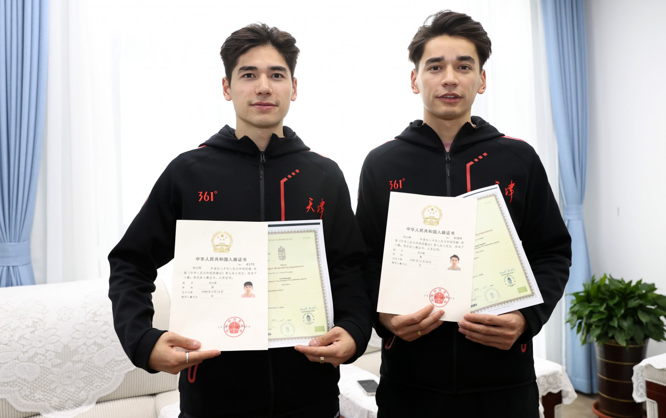 TIANJIN, CHINA - MARCH 25: Hungarian-born short-track speed skaters Sandor Liu Shaolin and Liu Shaoang, who will make their debut in China at the National Short Track Speed Skating Championships representing Tianjing, pose with their naturalization certificates on March 25, 2023 in Tianjin, China. (Photo by VCG/VCG via Getty Images)