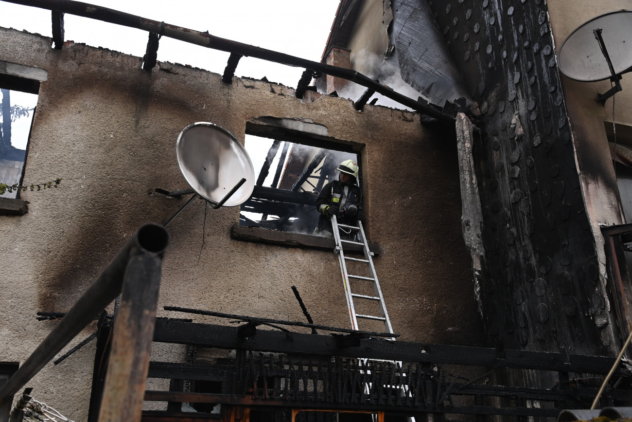 Szentendre, 2023. április 3.
Tűzoltó dolgozik egy kigyulladt családi ház oltásán Szentendrén 2023. április 3-án. A tűzoltók oltás közben egy idős nő holttestére bukkantak.
MTI/Mihádák Zoltán