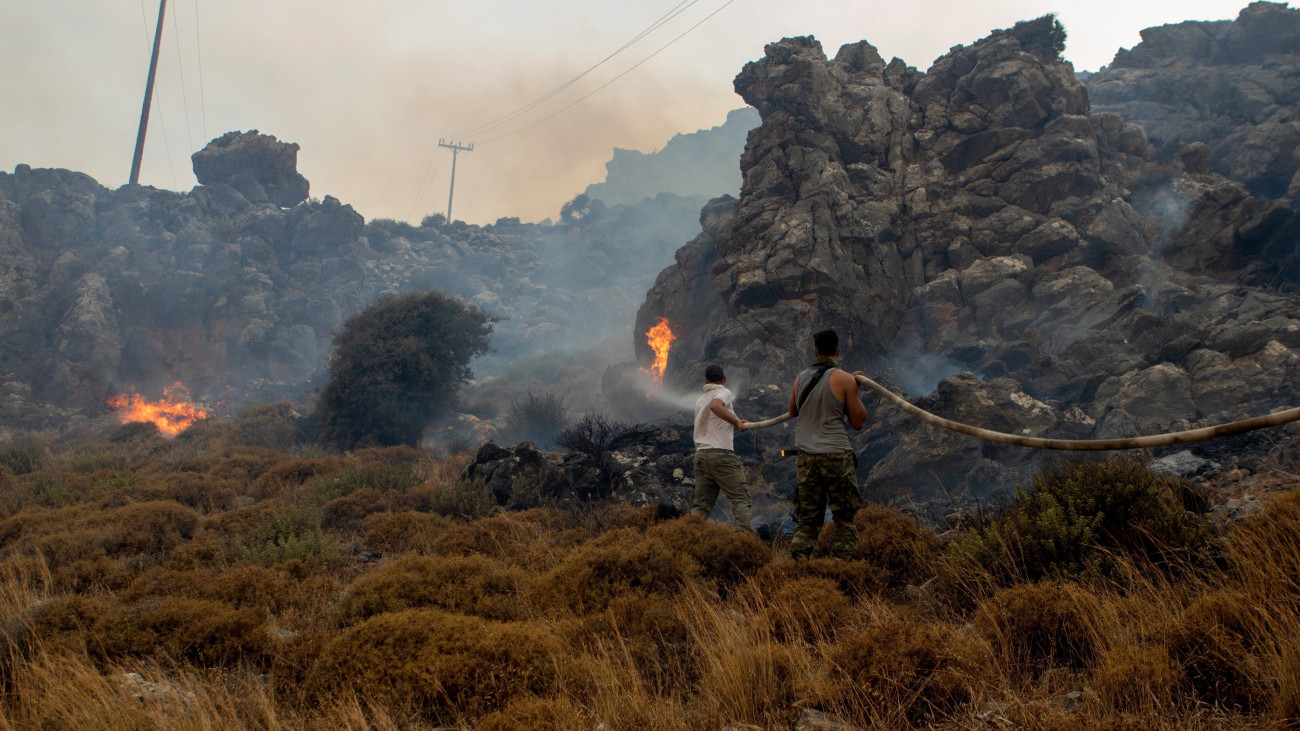 Kiotari, 2023. július 22.
Tűzfészket olt két férfi a Rodosz szigetén fekvő Kiotari falu határában 2023. július 22-én. A hőség és tartós csapadékhiány miatt Athén térségében is erdőtüzek pusztítanak.
MTI/EPA/ANA-MPA/Damianidisz Lefterisz