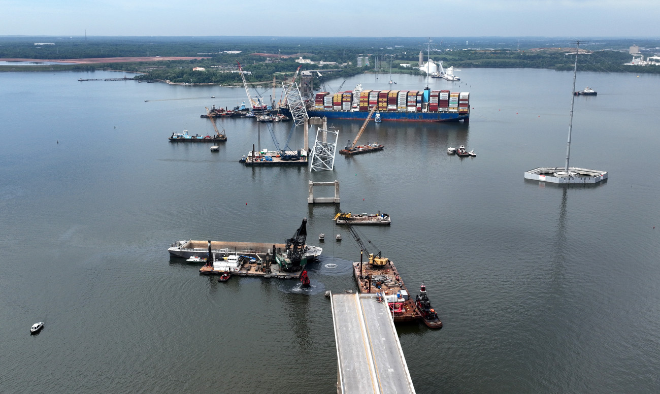 BALTIMORE, MARYLAND - MAY 08:  In this aerial view, salvage crews continue to remove wreckage from the Dali six weeks after the cargo ship collided with the Francis Scott Key Bridge May 08, 2024 in Baltimore, Maryland. Officials announced this week that precision explosive charges will be used to separate the Dali from the spans of the bridge that collapsed over its bow which should make it possible to move the ship and open a 45-foot channel in the Patapsco River. Salvage teams on Tuesday found remains of construction worker Jose Minor Lopez, the final missing victim of the March 26 collapse. (Photo by Chip Somodevilla/Getty Images)