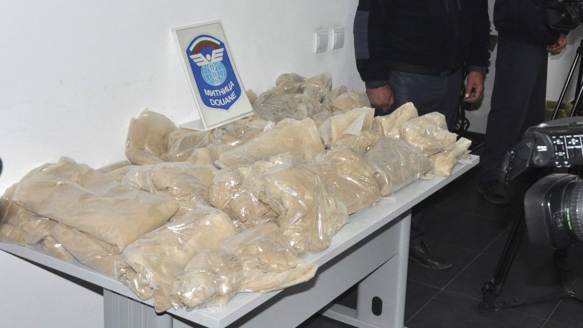 Kapitan-Andreevo, 2018. szeptember 29.Bolgár vámtisztek az általuk lefoglalt kábítószert tartalmazó csomagokat mutatják a sajtó képvilseőinek a bolgár-török határon fekvő Kapitan-Andreevo, 2018. szeptember 29-én. A hatóságok rekordmennyiségű, több mint 700 kilogramm heroint foglaltak le két, Ausztriába tartó iráni kamion rakterében. A nagy tisztaságú kábítószer feketepiaci értékét 23 millió euróra (csaknem 7,5 milliárd forintra) becsülik.  A két auto sofőrje rokoni kapcsolatban áll egymással, Mmndkettőjüket letartóztatták, büntetésük akár 15-20 év börtön is lehet. (MTI/AP/Sakarnews/Ivan Atanassov)