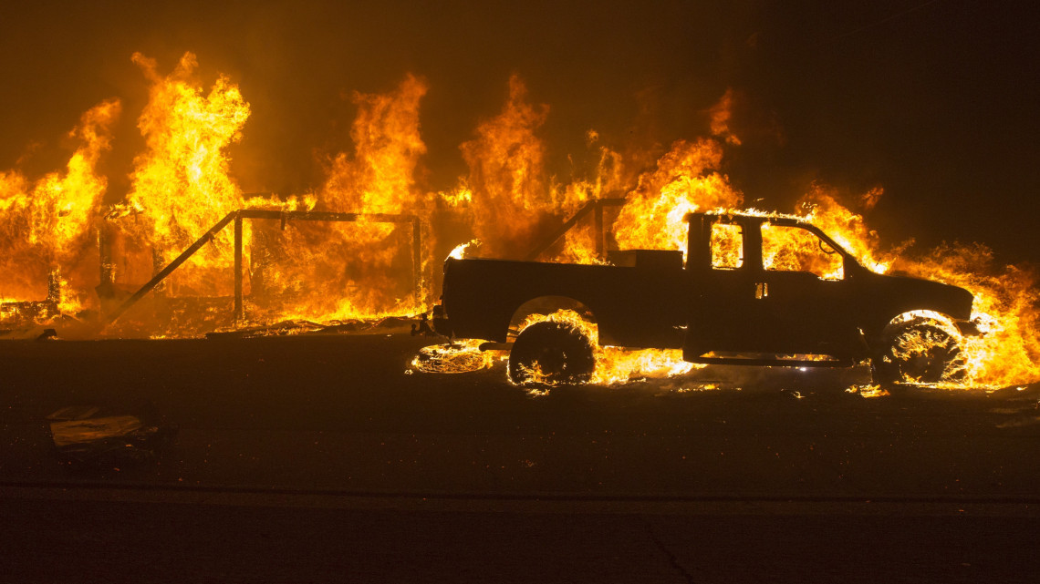 Lángok martalékává válik egy épület és egy autó a kaliforniai Buttle megyei Paradise közelében pusztító erdőtűzben 2018. november 8-án. Az alacsony páratartalom és az erős szél miatt gyorsan terjedő lángok miatt három északi megyében rendkívüli állapotot hirdettek és megkezdték a települések kiürítését. Paradise városban öt ember súlyosan megégett.