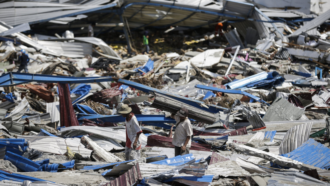 Mamboro, 2018. október 2.Házépítéshez használható anyagokat gyűjtenek férfiak egy megsemmisült raktárépület maradványai közt az indonéziai Celebeszen (Sulawesi) fekvő Mamboróban 2018. október 2-án. A szeptember 28-i, 7,5-ös erősségű földrengésnek és az azt követő szökőárnak legkevesebb 1234 halottja és nyolcszáz sérültje van. (MTI/EPA/Mast Irham)