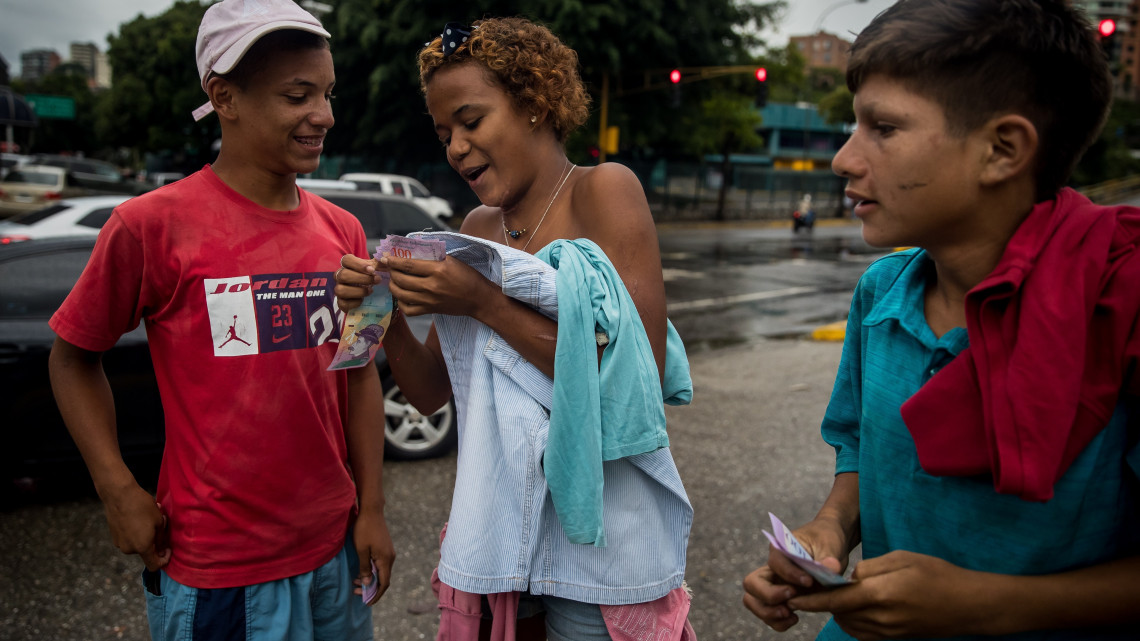 Caracas, 2019. január 30.
A 2018. november 4-i képen Paola, tizenöt éves venezuelai utcagyerek (k) a társaitól begyűjtött pénzt számolja Caracasban. Paola két évvel korábban hagyta ott családját, mert elmondása szerint éheztették. A venezuelai főváros utcáin élő hajléktalan tizenévesek többsége kéregetésből tartja fenn magát, a város élővizeiben mosdik, háztartási hulladék közt keres ennivalót és sokuk kábítószert használ. A közoktatásból kieső, kallódó kiskorúak az egyik legkiszolgáltatottabb csoport a súlyos gazdasági és társadalmi válsággal küzdő, olajban gazdag dél-amerikai országban. A zűrös családi hátterű fiatalok egy része vidékről menekül a fővárosba.
MTI/EPA/Miguel Gutiérrez