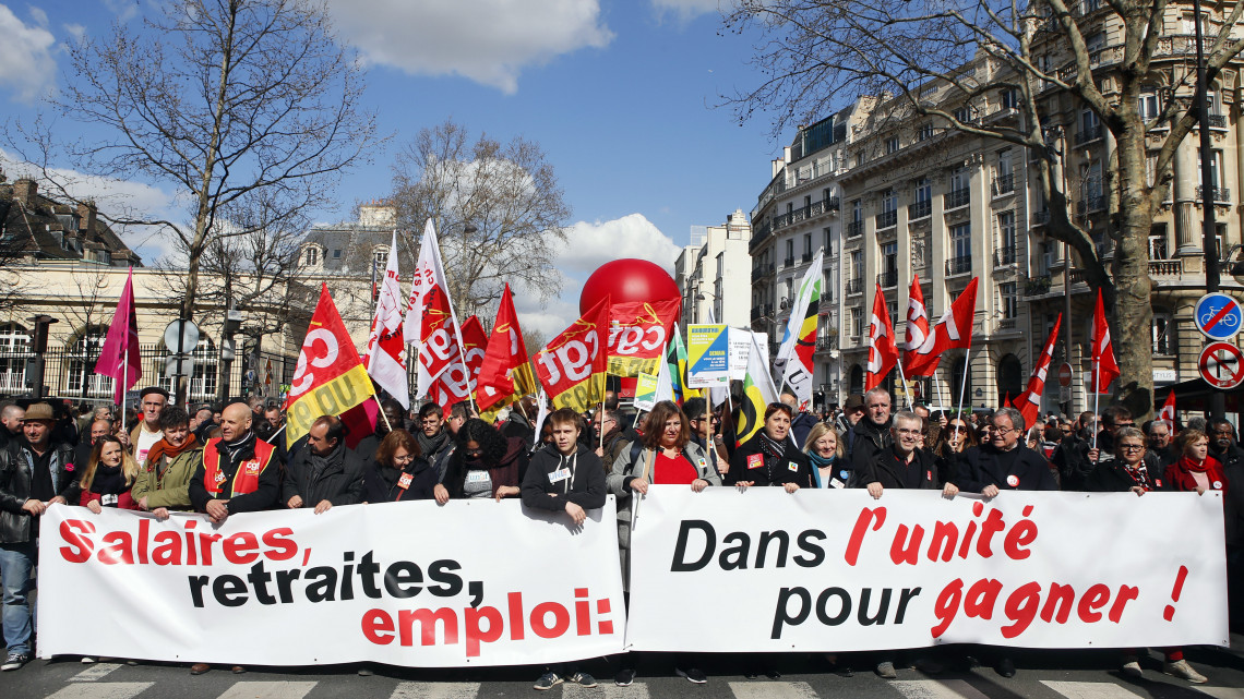 Francia munkavállalók tüntetnek Párizsban a több szakszervezet felhívására tartott országos sztrájknapon, 2019. március 19-én. A tüntetők életkörülményeik javítását követelik a francia kormánytól. A transzparens feliratának jelentése: bérek, nyugdíjak, foglalkoztatás: egységben a győzelemért.