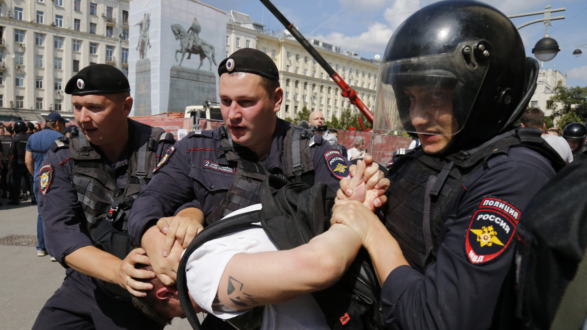 Engedély nélküli ellenzéki tüntetés résztvevőjét veszik őrizetbe rendőrök Moszkvában 2019. július 27-én. A tüntetők amiatt tiltakoztak, hogy a választási bizottságok elutasították a szeptember 8-i önkormányzati választásokon indulni szándékozó ellenzéki és független jelöltek jegyzékbe vételét.
