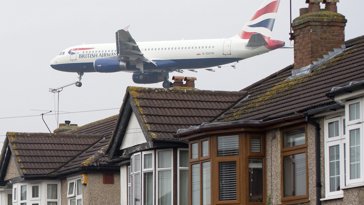 London, 2016. október 25.A British Airways légitársaság egyik gépe a lakóházak felett repül útban a londoni Heathrow repülőtérre 2016. október 25-én. A repülőtér harmadik, új kifutópályájának megépítését a Heathrow szomszédságában fekvő települések lakosainak többsége és a környezetvédő mozgalmak is ellenzik. (MTI/EPA/Hannah McKay)