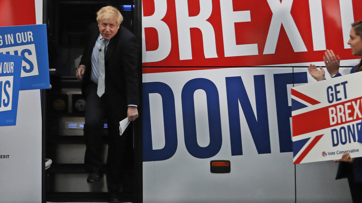 Britains Prime Minister Boris Johnson addresses his supporters prior to boarding his General Election campaign trail bus in Manchester, England, Friday, Nov. 15, 2019. Britain goes to the polls on Dec. 12. (AP Photo/Frank Augstein, Pool)