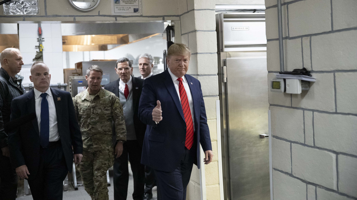 Donald Trump amerikai elnök (j) vacsorát készül osztani a bagrami légi támaszponton szolgáló amerikai katonáknak, akiket a hálaadás ünnepének alkalmából keresett fel meglepetésszerű afganisztáni látogatása alatt, 2019. november 28-án.
