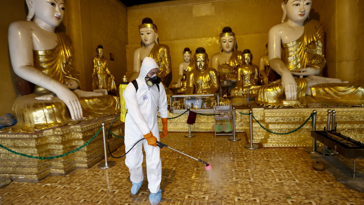 A ranguni Svedagon pagodát fertőtlenítik az új koronavírus járványa elleni védekezésképpen 2020. március 31-én. A mianmari egészségügyi minisztérium közlése szerint ezen a napon halt meg a vírus első áldozata az országban, ahol jelenleg 14 fertőzöttet tartanak nyilván.