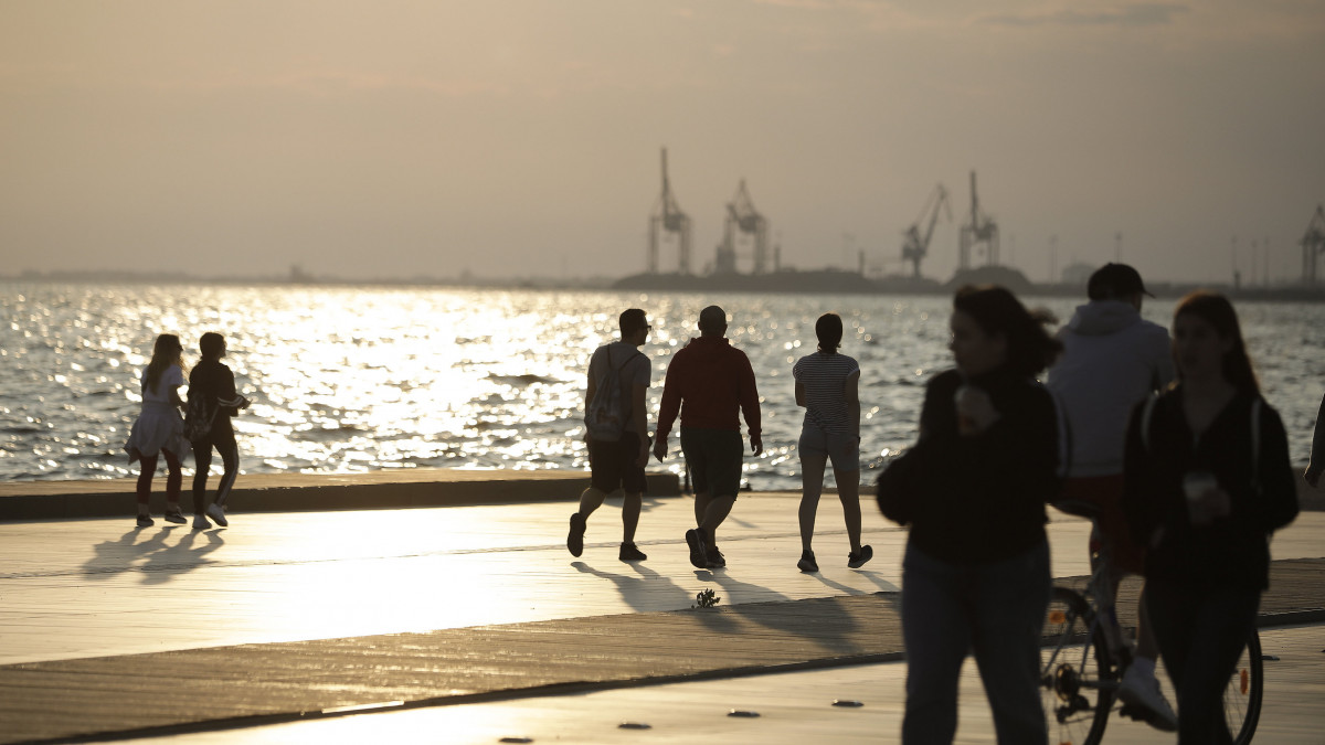 Sétálnak az emberek élvezik a tavaszi napsütést a görögországi Thesszaloniki tengerpartján 2020. április 28-án, miután a városnak erre a részére ettől a naptól kezdve nem vonatkoznak a kijárási korlátozásokat.