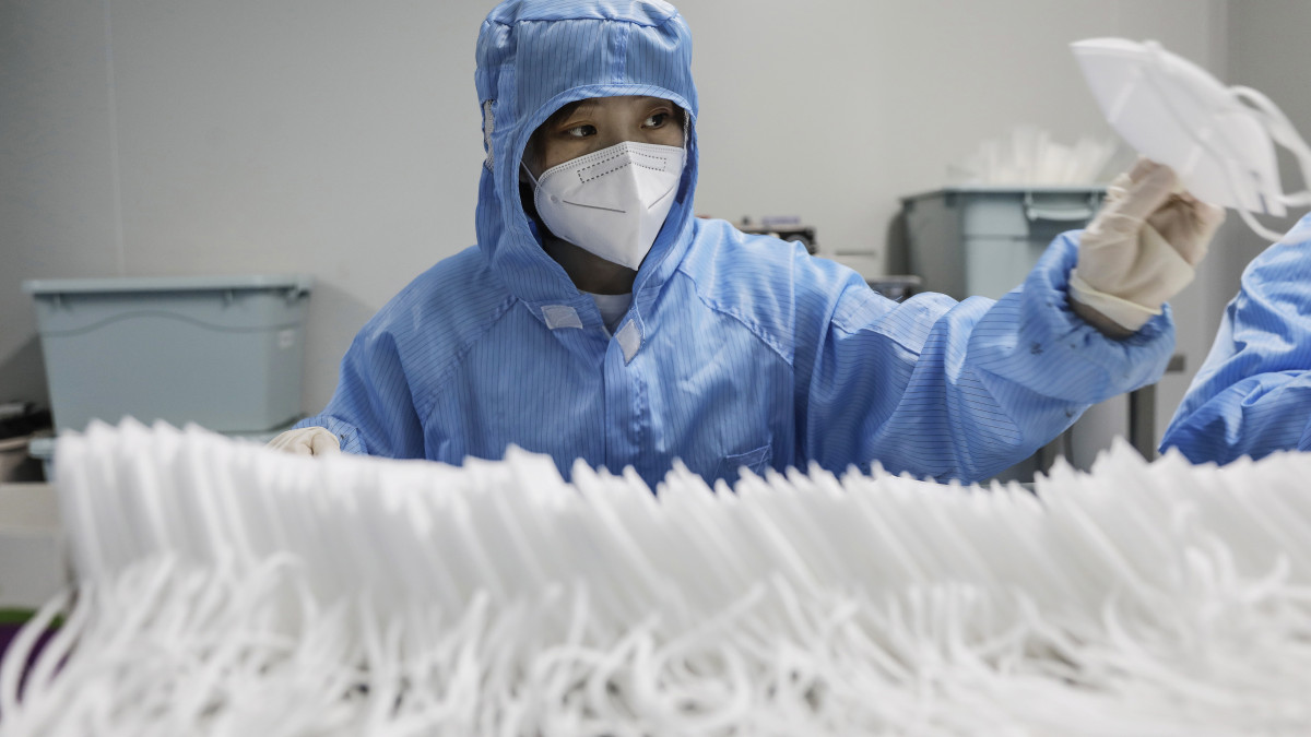 A koronavírus-járvány miatt védőfelszerelést viselő dolgozó a kínai Naton Biotechnology vállalat arcmaszkokat gyártó pekingi üzemében 2020. április 29-én. Az üzemben eddig ortopéd sebészeti eszközöket készítettek, és 2020 februárjában álltak át a védőmaszkok gyártására, amelyekből naponta körülbelül ötmillió készül.