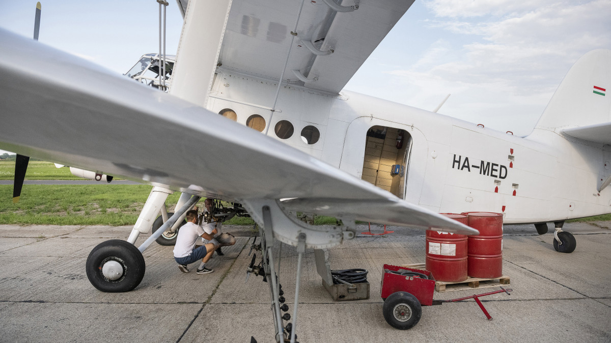 A Tréner Kft. munkatársai ellenőrzik az egyik szúnyogirtásra átalakított repülőgép szórófejeit a nyíregyházi repülőtéren 2020. július 22-én.