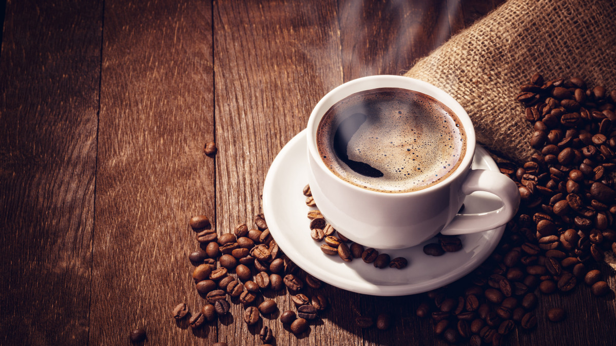 Cup coffee beans wooden dark background