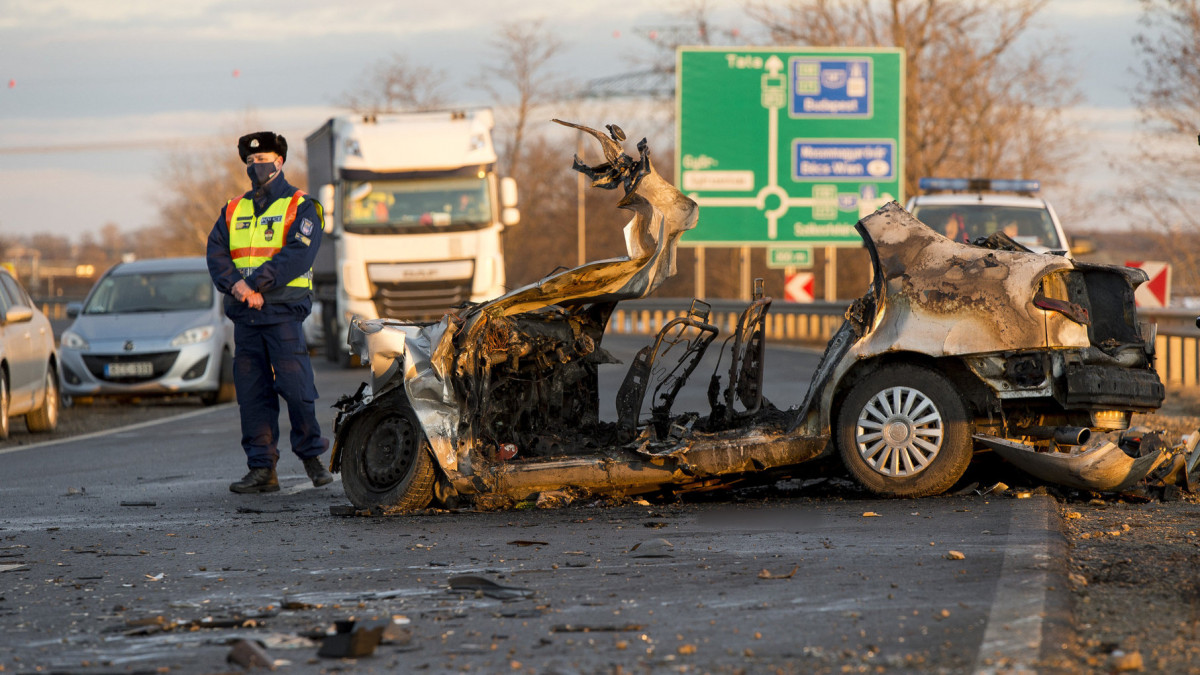 Összeroncsolódott, kiégett személygépkocsi, miután egy autószállító teherautóval ütközött a 813-as számú úton, Győr közelében 2021. január 14-én. A személyautóban utazó négy ember életét vesztette.