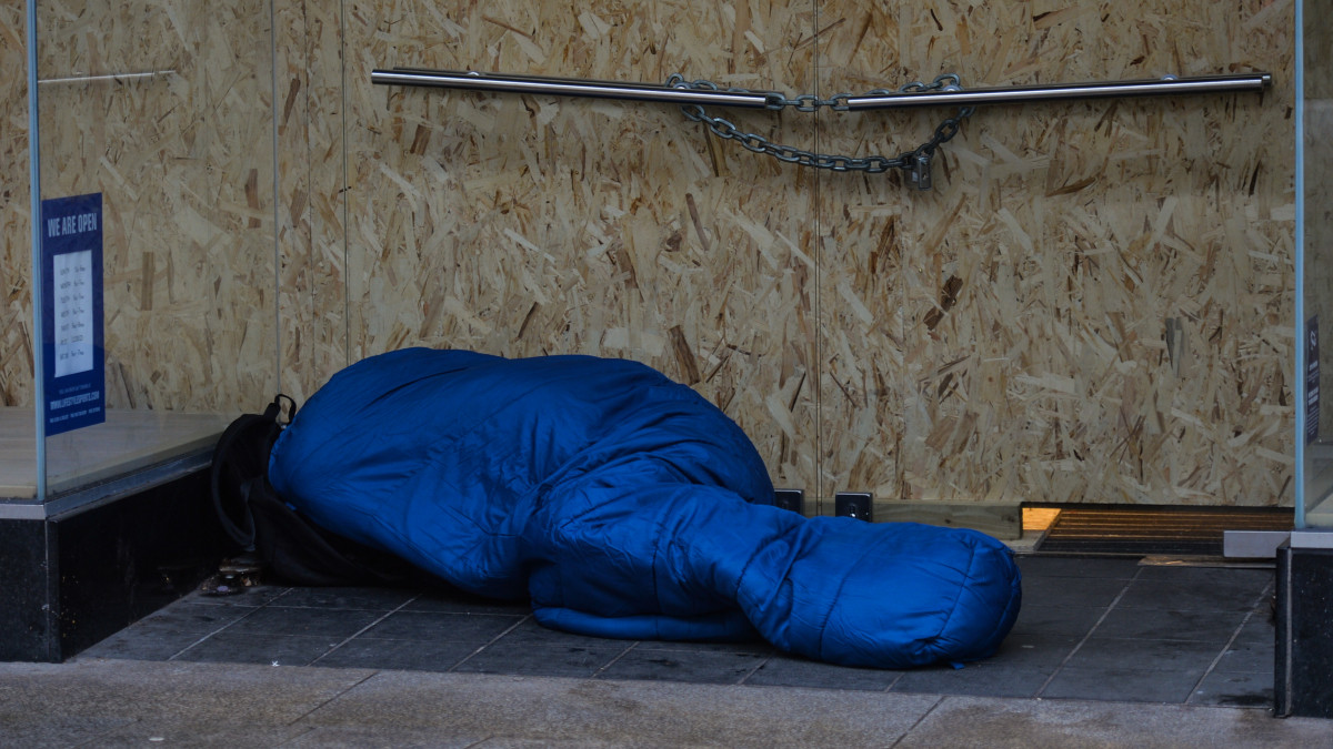 A view of a rough sleeper at the entrance to a closed shop in Dublin city center, during Level 5 Covid-19 lockdown.  Irelands health service is potentially facing the most challenging week in its history with the number of Covid-19 patients requiring intensive care treatment having risen sharply since the end of December.  The Department of Health reported this evening 1,975 Covid-19 patients were in hospital with the virus across the country, of which 200 are in intensive care.  On Monday, 18 January, 2021, in Dublin, Ireland. (Photo by Artur Widak/NurPhoto via Getty Images)