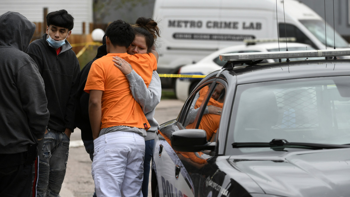 COLORADO SPRINGS, COLORADO - MAY 9: Nubia Marquez, right, whose mother was one of six shooting victims, hugs family member Edgar Ortiz, with back to camera, outside the scene of the shooting at the Canterbury Mobile Home Park on May 9, 2021 in Colorado Springs, Colorado. A gunman killed six people at a family birthday party before taking own life, police said. The victims were all members of the same extended family a party attendee said. The shooting was in the 2800 block of Preakness Way in the Canterbury Mobile Home Park. The shooting happened just after midnight. Colorado Springs police Lt. James Sokolik said in a news release. Investigators believe the shooter, who has not been publicly identified, was the boyfriend of a woman at the party. (Photo by Helen H. Richardson/MediaNews Group/The Denver Post via Getty Images)