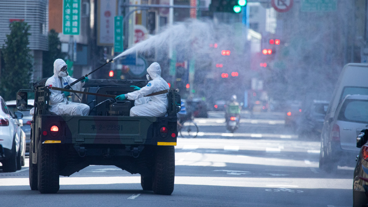 Disinfectioner sprays disinfection in the street in Wanhua District, Taipei, Taiwan on May 16, 2021. (Photo by Annabelle Chih/NurPhoto via Getty Images)