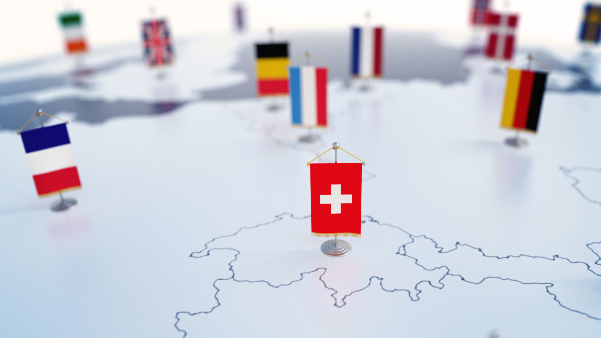 Flag of Switzerland in focus among other European countries flags. Europe marked with table flags 3d rendering