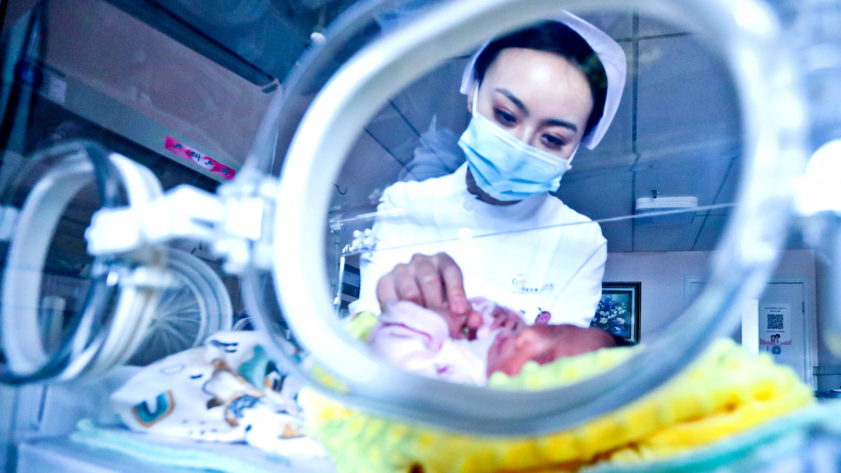 ZHANGYE, CHINA - MAY 26, 2021 - A medical worker shines a blue light on a newborn baby in a hospital ward in Zhangye City, Gansu Province, China, May 26, 2021. (Photo credit should read Costfoto/Barcroft Media via Getty Images)