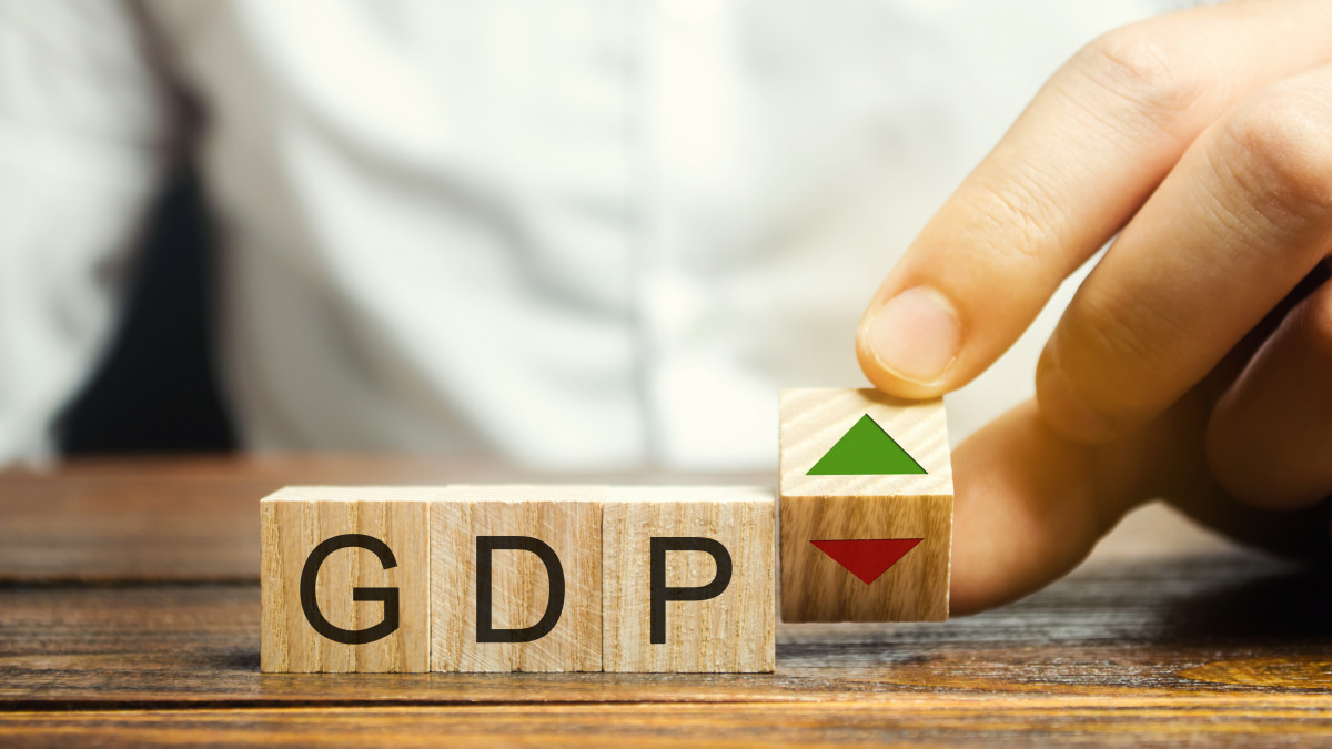 Wooden blocks with the word GDP and up and down arrows. An unstable economy in the country. Financial measure of the market value of all the final goods and services produced in a specific period.