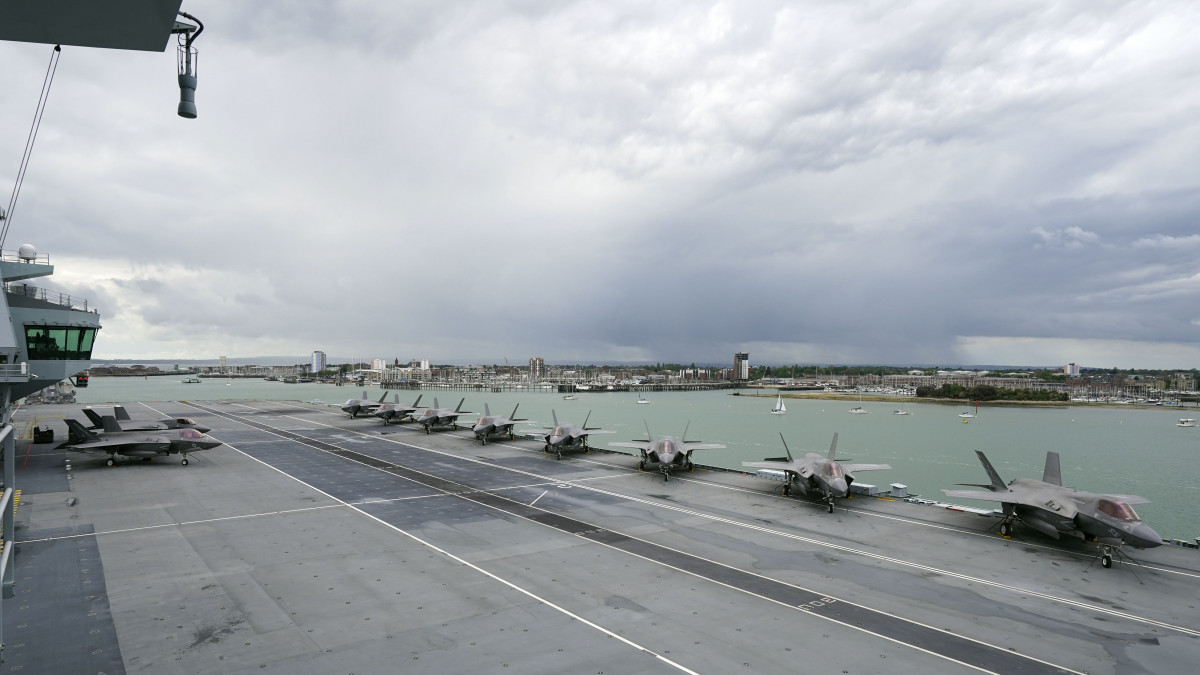 PORTSMOUTH, ENGLAND - MAY 22: F-35B aircraft on the flight deck during Queen Elizabeth IIs visit to HMS Queen Elizabeth at HM Naval Base ahead of the ships maiden deployment on May 22, 2021 in Portsmouth, England. The visit comes as HMS Queen Elizabeth prepares to lead the UK Carrier Strike Group on a 28-week operational deployment travelling over 26,000 nautical miles from the Mediterranean to the Philippine Sea. (Photo by Steve Parsons - WPA Pool / Getty Images)