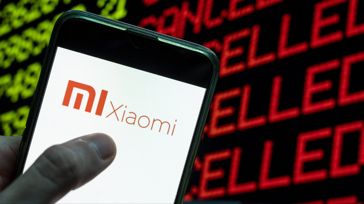 CHINA - 2021/04/24: In this photo illustration the Chinese electronics manufacturer company Xiaomi logo seen displayed on a smartphone with the word cancelled on a computer screen. (Photo Illustration by Budrul Chukrut/SOPA Images/LightRocket via Getty Images)